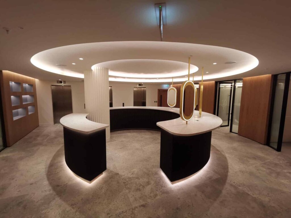Curved and shaped reception desk using cream veined Solid Surface