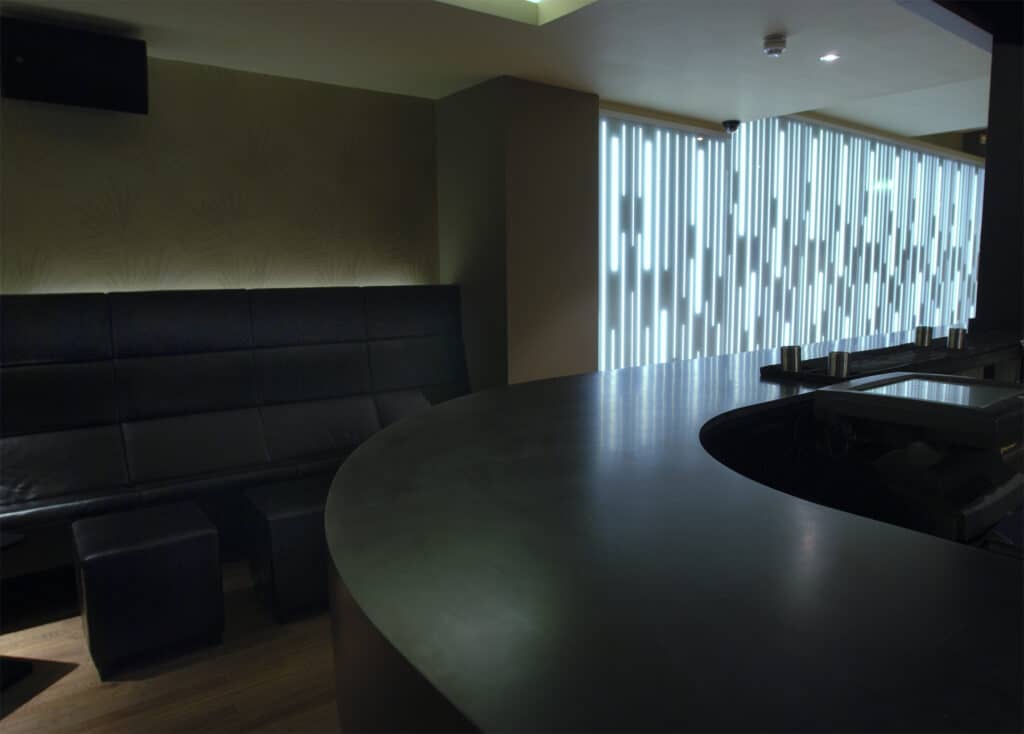 Black Curved HIMACS Thermoformed Bar in Solid Surface in Hospitality Design