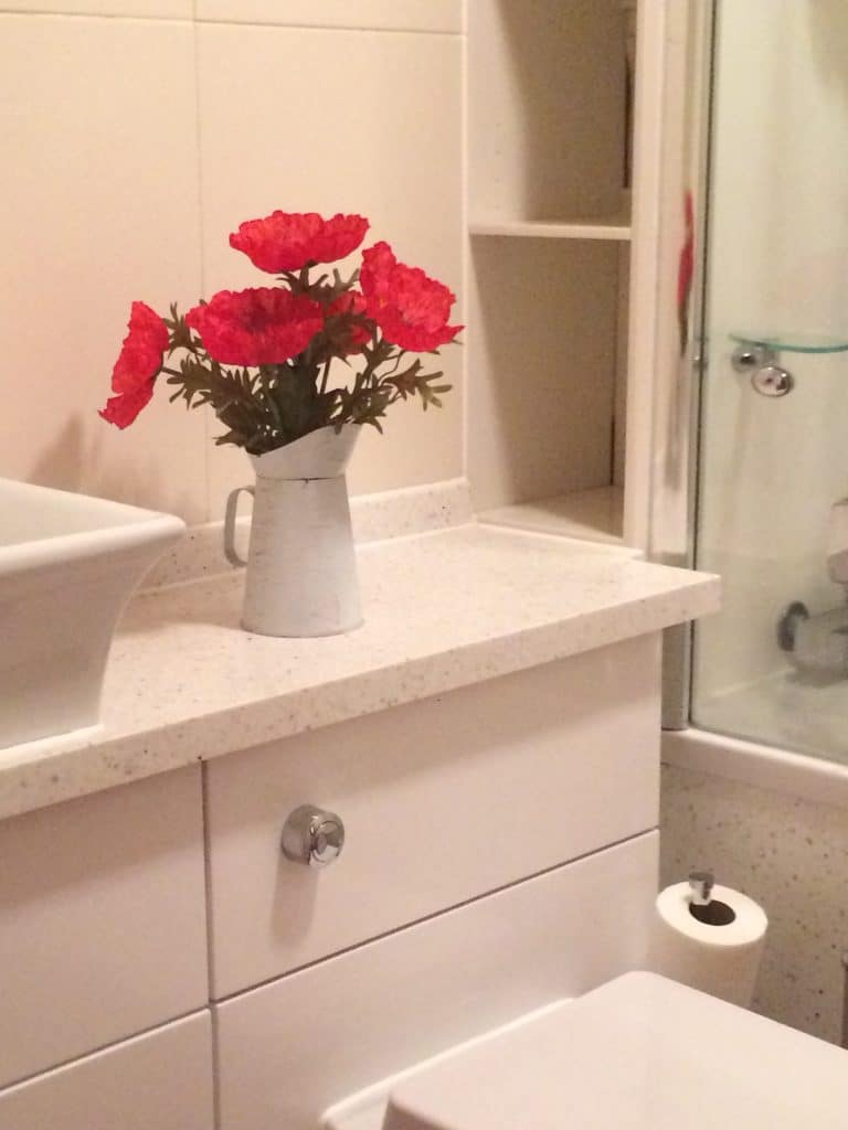 White Speckled Solid Surface vanity shelves and bathsurround