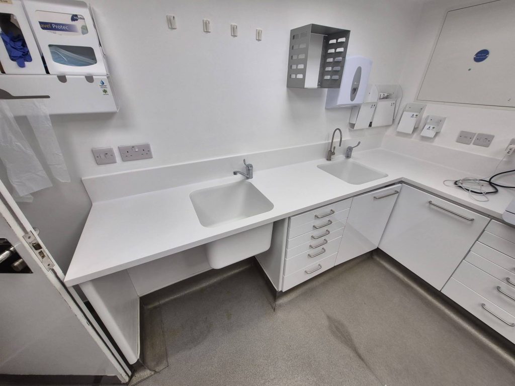Solid surface dental surgery worktops with integrated sink | Coved upstand on clinical worktop | Decontamination room solid surface worktop run